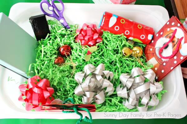 gift wrap sensory bin  materials in a container